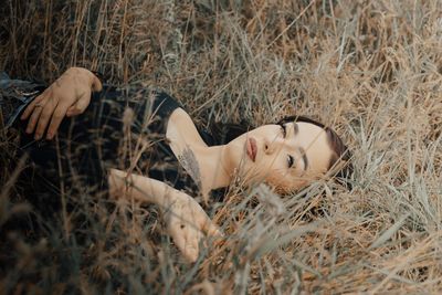 Low section of woman lying on field