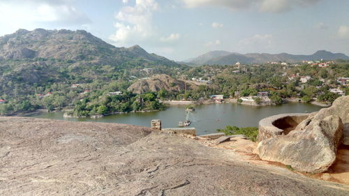 Scenic view of lake and mountains against sky