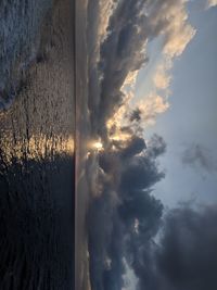 Scenic view of sea against dramatic sky during sunset