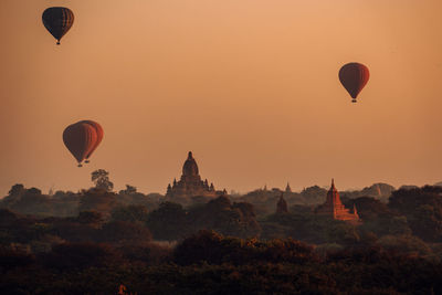 Hot air balloons against sky during sunset