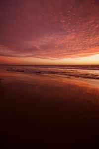 Scenic view of sea against romantic sky at sunset