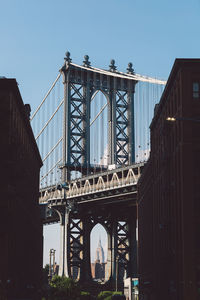 Low angle view of manhattan bridge against sky