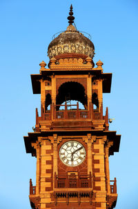 Low angle view of ghanta ghar against clear blue sky