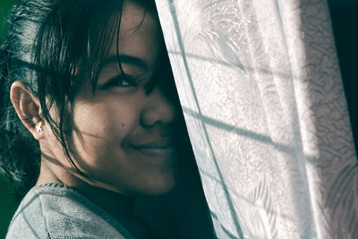 Close-up portrait of a smiling young woman