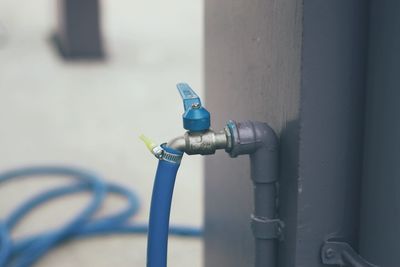 Close-up of faucet against wall