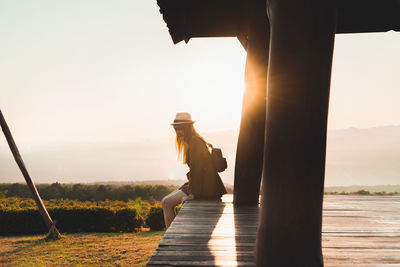 People at observation point against sky during sunset