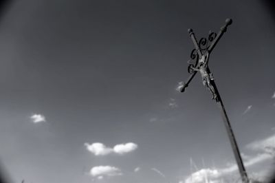 Low angle view of jesus christ on cross against sky