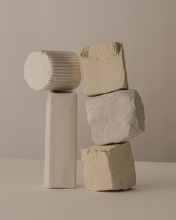 Close-up of stack on table against white background