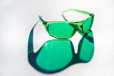 Close-up of sunglasses on table against white background
