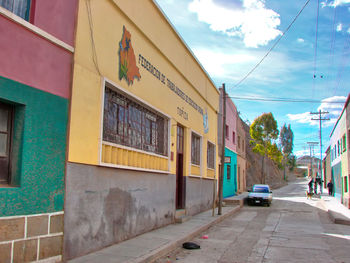 Road by building against sky in city