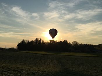 View of hot air balloon over grassy field