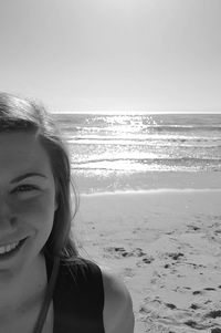 Close-up of woman at beach against sky