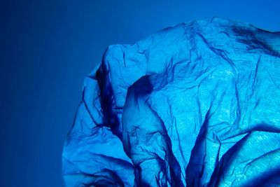 Close-up of crumpled paper against black background