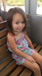 Portrait of cute girl sitting outdoors