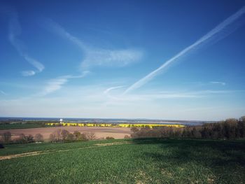 Scenic view of landscape against blue sky