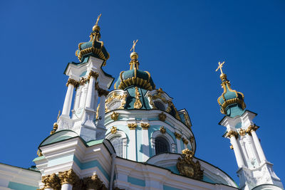 Low angle view of bell tower against blue sky