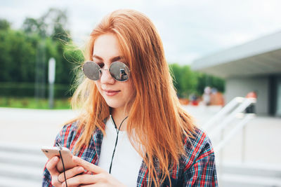 Close-up of female student listening to music