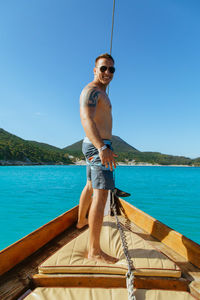 Man standing by sea against sky