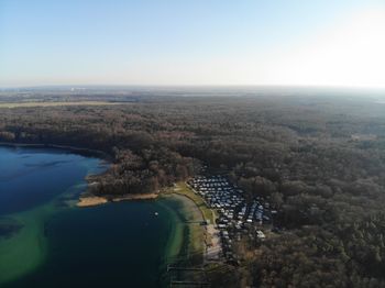 High angle view of river amidst city against clear sky