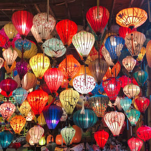 Low angle view of illuminated lanterns hanging at night