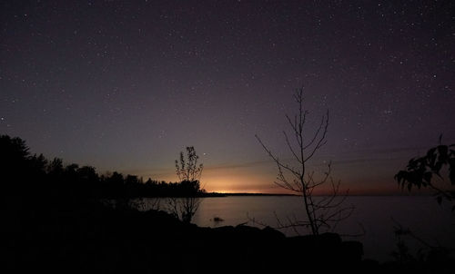 Scenic view of lake against sky at night