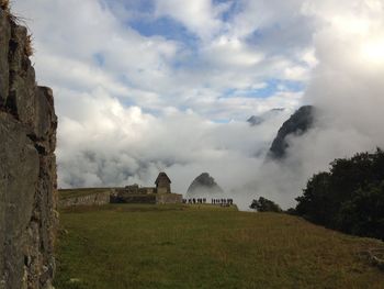 Built structure on field against sky