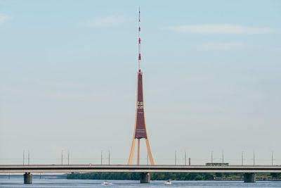 Suspension bridge over river against sky