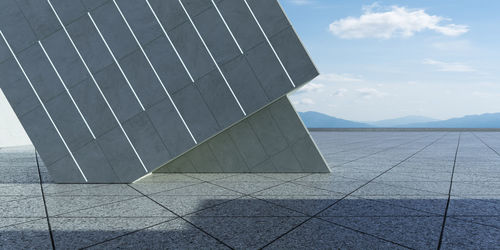 Tilt image of metallic structure against sky