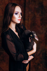 Close-up teenage girl holding cat