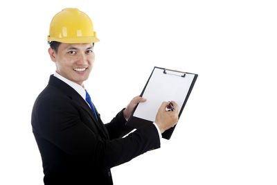 Man wearing hat holding camera against white background