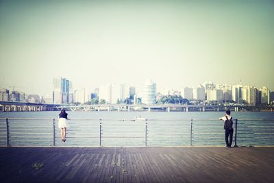 Woman standing in front of cityscape