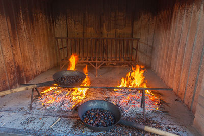 Chestnuts cooked on couple of iron pans over the fire