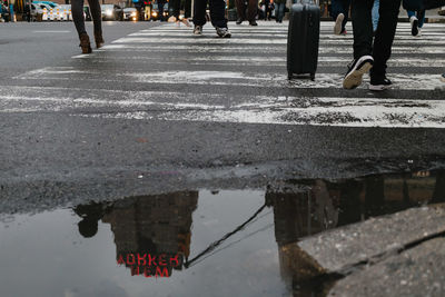 Low section of people walking on road