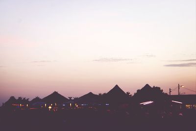 View of illuminated built structures at sunset