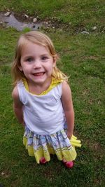 Portrait of girl lying on grassy field