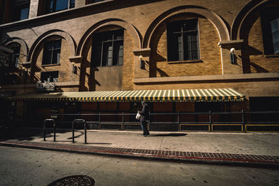 People walking on street by building