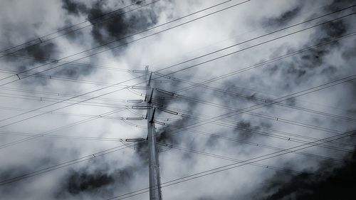 Low angle view of electricity pylon against sky