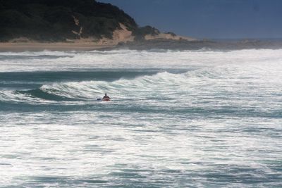 Man kayaking in sea