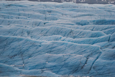 Turquoise glacier covering ground landscape photo