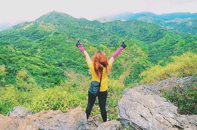 Full length of woman standing on mountain