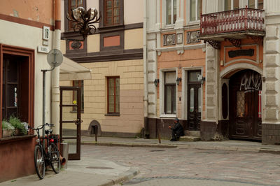 Man walking on street by building