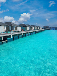 View of swimming pool in sea against blue sky