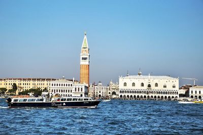 View of buildings in city against clear sky