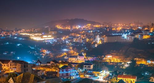 High angle shot of illuminated cityscape against sky at night