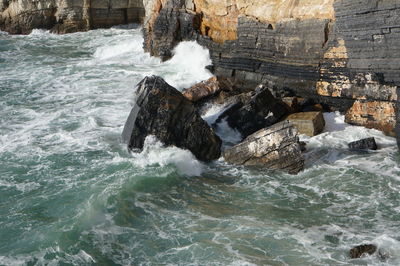 Water flowing through rocks in sea