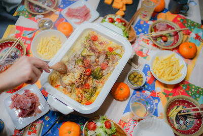 High angle view of person preparing food served on table