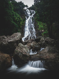 Scenic view of high waterfall in lush rainforest. long exposure. sarika fall, nakhon nayok, thailand