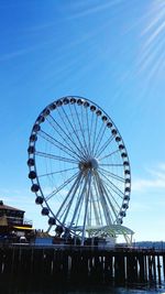 Low angle view of ferris wheel against sky