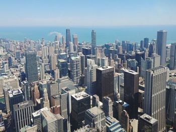 Aerial view of modern buildings in city against sky