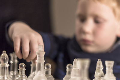 Close-up of boy playing chess